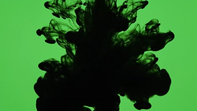 Spreading Black Ink Smoke Cloud With Fluid Motion On Green Screen Background For Cinematic Visual Effects
