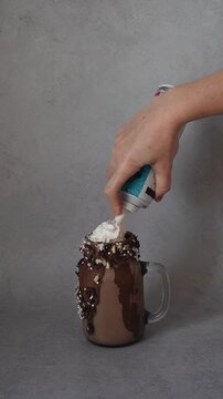 Step-by-Step Decorating a Chocolate Freak shake with Whipped Cream and Cookies