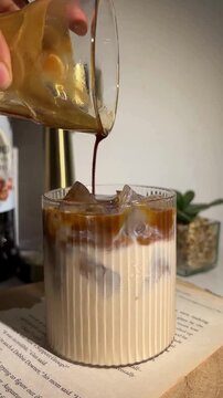 Pouring Espresso Shot into Iced Milk creating Aesthetic Coffee Swirls
