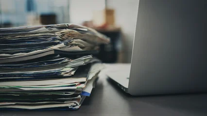 Fotobehang Karaktertjes A pile of papers next to the laptop  © sebra