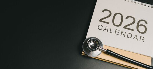 Annual health check-up. 2026 calendar with stethoscope on black surface symbolizing medical planning and health schedule for future