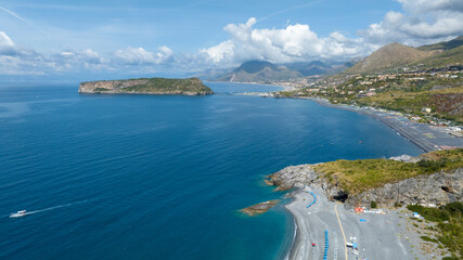 Obraz premium Aerial view of Fiuzzi beach, located on the Tyrrhenian coast of Calabria, in the province of Cosenza, Italy. It is a summer tourist destination. In the background is the Island of Dino, a tidal island