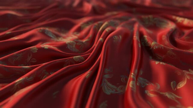 Close-up of rich red draped fabric with elegant golden floral patterns, showcasing luxurious texture and flowing folds under soft light, ideal for sophisticated backgrounds