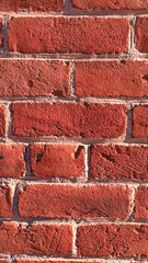 Obraz premium Textured red brick wall background with natural pattern and copyspace for design concepts - construction, architecture, design concept
