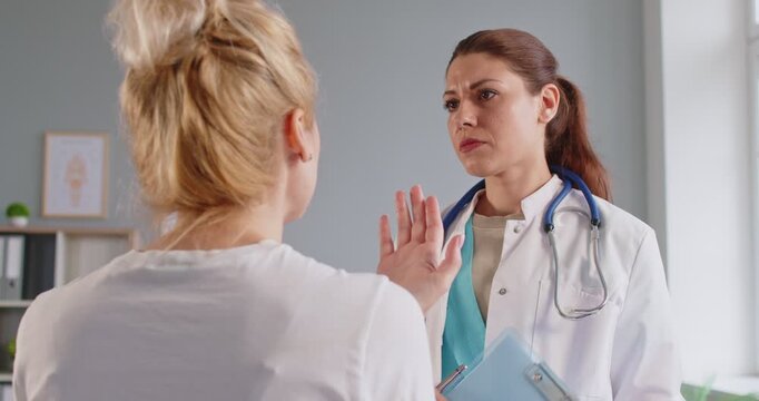 Doctors support for woman with bad news diagnosis and health prognosis, meeting in hospital. Sad patient talking about anxiety and despair to medical professional, in need of comfort and hope