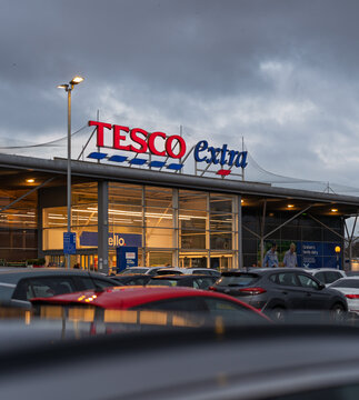 Tesco Extra supermarket building facade and parking lot at Elgin, Moray, Scotland on a very grey, overcast day