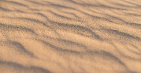 Fototapeta premium Artistic peaceful golden sand texture tranquil natural wall art background, relax gold pastel sandy abstract dunes wallpaper luxury minimal decor. Beautiful nature sunny closeup view summer beach