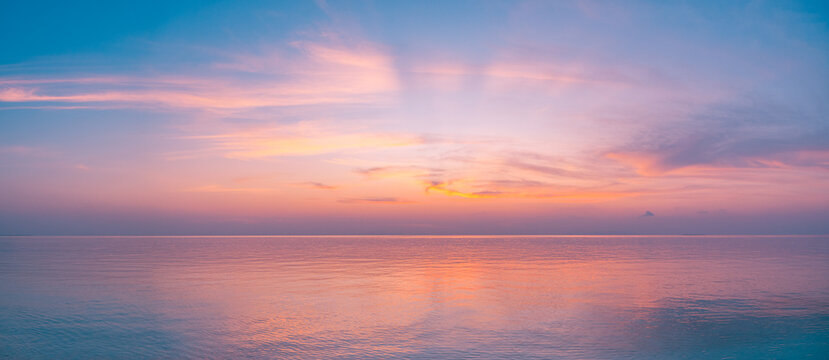 Magical Panoramic Sunset Over Calm Ocean with Romantic Colorful Clouds and Breathtaking Sunlight &ndash; Tranquil Seascape Horizon