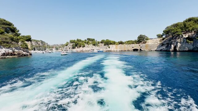 Calanque de Port Miou seen from the sea during a boat trip, showing steep limestone cliffs, deep blue Mediterranean water on the French Riviera, Cote d&rsquo;Azur, near Cassis, France.