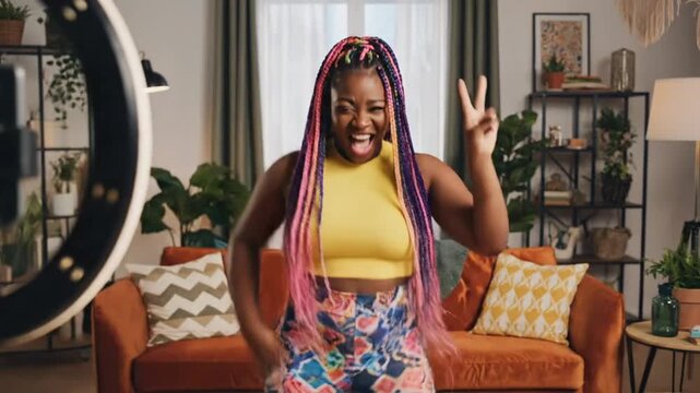 Content creator shares tips while standing in a living room with bright colors and a ring light