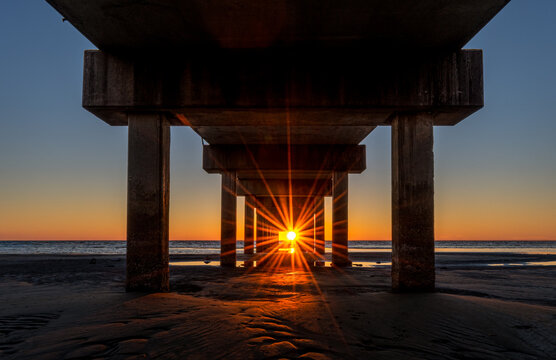 Dramatic Sunburst underneath Fishing Pier
