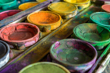 Detailed close up of colorful paint box set. Macro shot of watercolor set. Impressive bright color show concept of creativity with copy space.