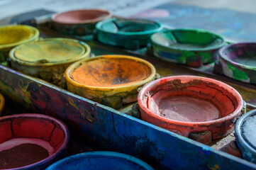 Detailed close up of colorful paint box set. Macro shot of watercolor set. Impressive bright color show concept of creativity with copy space.