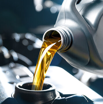 Pouring engine oil into car engine