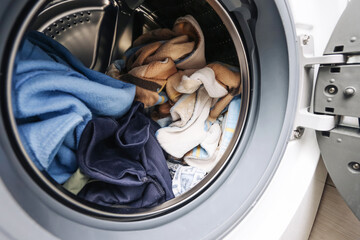 Washing towels and cleaning cloths inside front loading washing machine drum. Household laundry...