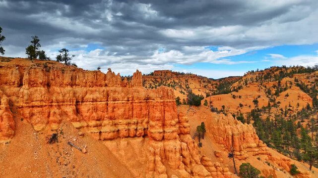 Columned rock formations in Red Canyon, Utah, USA. Scarce pine trees grow along the landscape. Aerial view.
