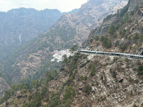 Pilgrimage journey to Vaishno Devi Temple featuring devotees walking the mountain trail through scenic hills and spiritual surroundings in Jammu and Kashmir.