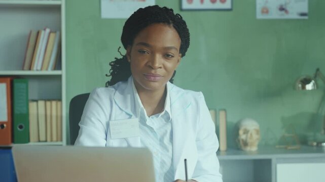 Experienced female medical practitioner thoroughly documents findings while caring for young patient in clinical setting