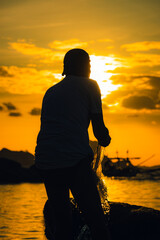 silhouette of a man on the beach during sunrise