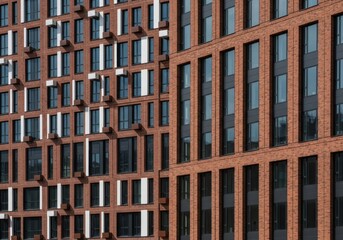 Modern brick facades of urban buildings showcasing contrasting architectural patterns and reflective windows