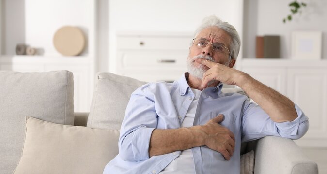 Amnesia. Senior man trying to remember something at home, space for text