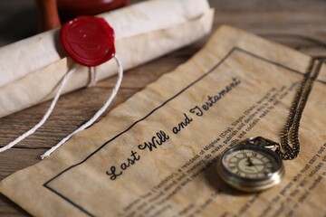Last Will and Testament, chain watch and paper scroll on wooden table, closeup