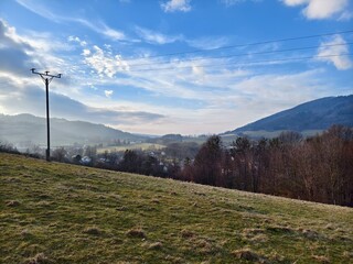 landscape with a power pole on a hill