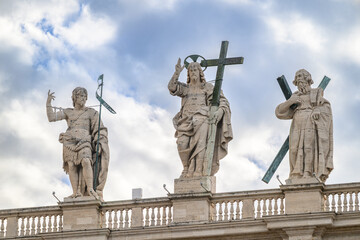 Fototapeta premium Christ the Redeemer (by Cristoforo Stati) flanked by St John the Baptist and St Andrew the Apostle atop St Peter’s Basilica in Rome.