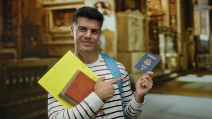 Young man holding a united states passport and pointing at it inside a church setting with books, showcasing travel and education themes. © Krakenimages.com