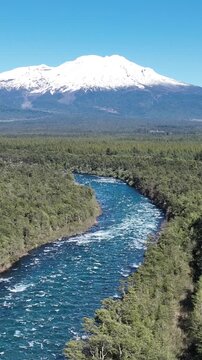 Calbuco Volcano At Llanquihue Lake Los Lagos Chile. Snow(Capped Volcano Releasing Plumes Of Smoke Into Blue Sky. Outdoor Travel Destination Patagonia Glacier. Outdoors Patagonia Aerial View Floresta.