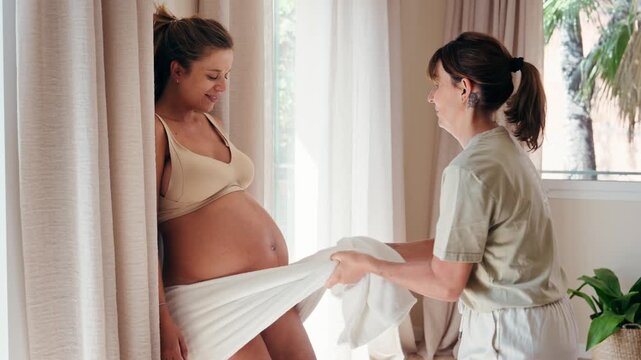 Video of tired pregnant woman doing rebozo exercises for childbirth with the physiotherapist at the clinic