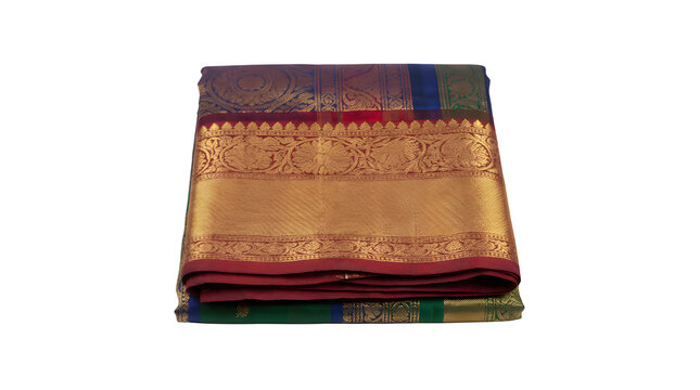 Stack of richly detailed, traditional South Indian silk sarees featuring heavy gold zari borders and intricate patterns.