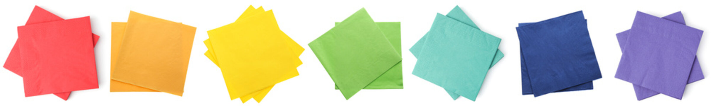 Paper napkins arranged in rainbow colors isolated on white, set. Top view