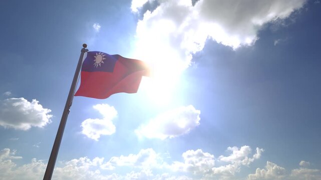Taiwan Flag waving on a Flagpole from a Moving Angle in front of a blue sky with clouds	