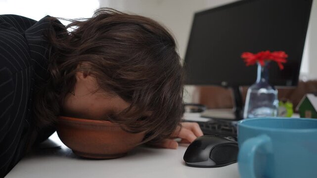 Exhausted female office worker or remote employee napping at her desk during breakfast. Burnout and career fatigue concept