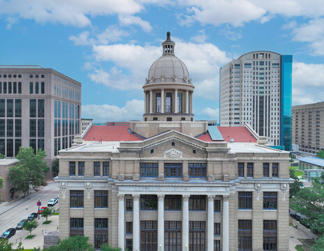 Aerial drone photo of the historic Harris County Courthouse in downtown Houston, Texas. This high-resolution image captures the iconic Beaux-Arts architecture and prominent clock tower