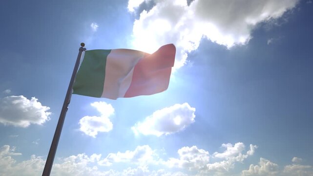 Ireland Flag waving on a Flagpole from a Moving Angle in front of a blue sky with clouds	