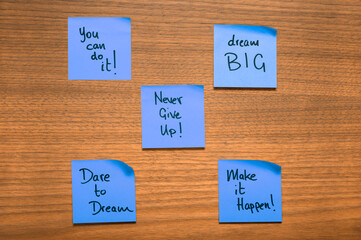 Purple-Blue Motivational Sticky Notes on Wooden Surface