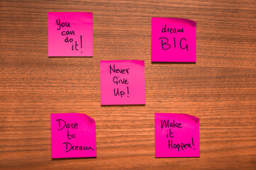 Pink Motivational Sticky Notes on Wooden Surface