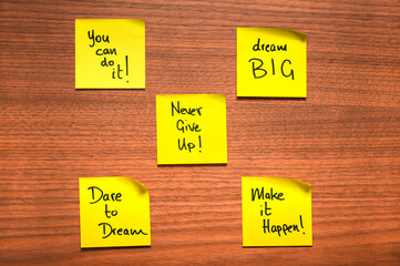 Yellow Motivational Sticky Notes on Wooden Surface