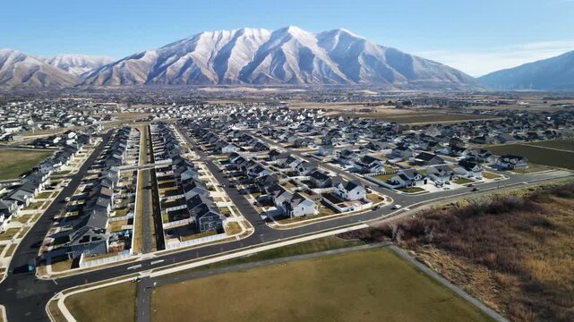 Aerial view of beautiful suburbs with snow peaked mountains in the distance