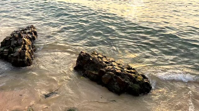 Boat moves in sea sunset. Marina with fishing boats at pier. Sunset marina with boats. Waves in ocean at coast. Boat sails in sea at sunset. Fishing dock in sea on bright sunset in Vietnam. 