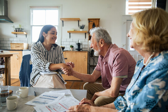 Financial advisor meeting senior couple at home
