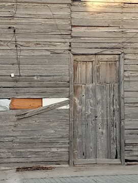 A wooden wall with a wooden door rustic style