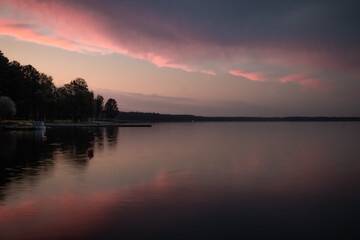 Obraz premium Serenity landscape panorama. Evening lake with dramatic sky and sunset