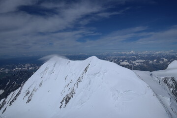 Tranquil Lake With Lush Green Forest, Snow-Capped Mountain, Blue Sky And White Clouds