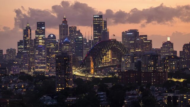 Twilight timelapse of Sydney CBD city skyline with harbor bridge and fireworks display.