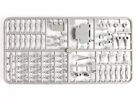Top view of grey plastic model kit sprue isolated on white background