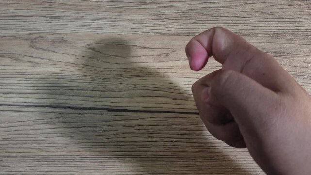 Hand crumpling a paper filled with today&rsquo;s diary writing, expressing frustration, emotional release, disappointment, reflection, or letting go of personal thoughts.