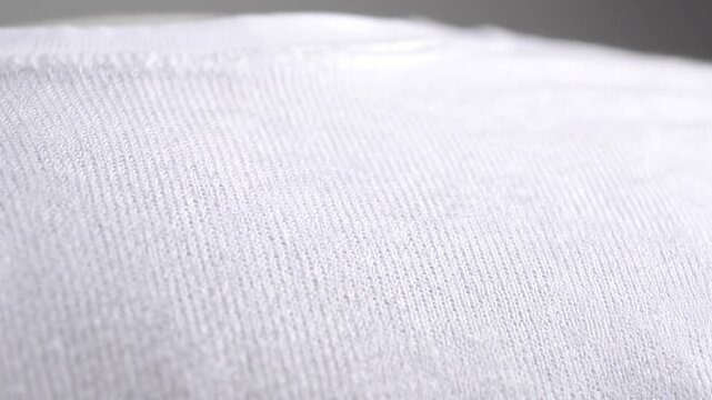 Close-up view of a white fabric texture with a subtle weave pattern